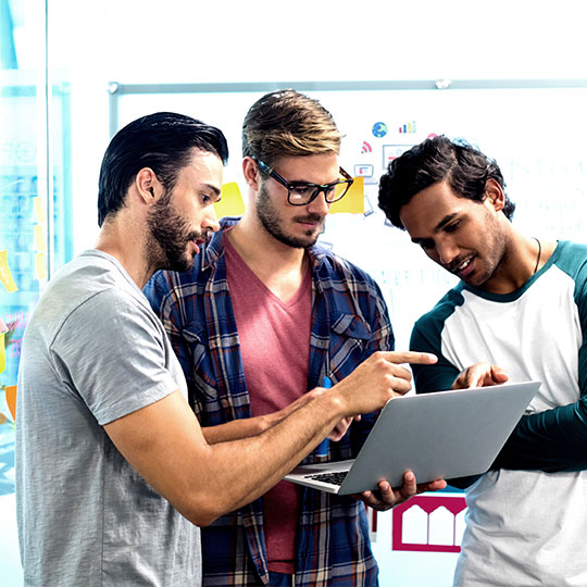 office workers looking at a laptop
